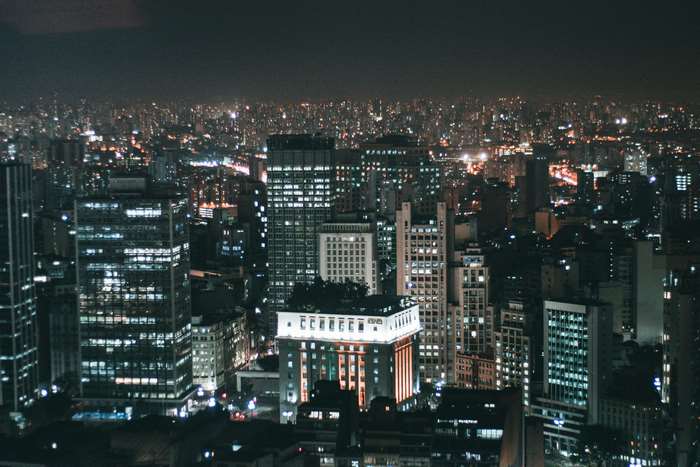 Cityscape at night with illuminated skyscrapers