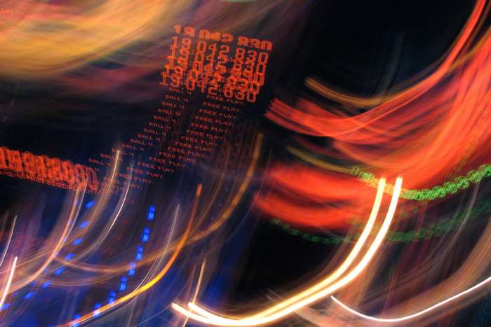 Abstract motion blur of pinball machine lights and numbers