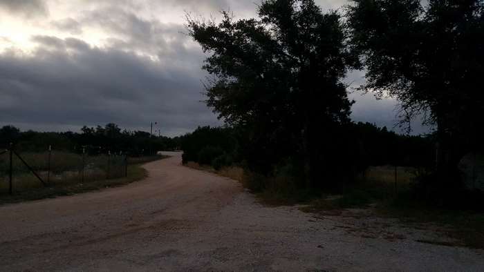Country lane under cloudy sky