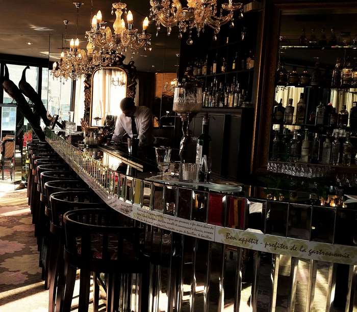 Luxurious bar with chandeliers and alcohol bottles