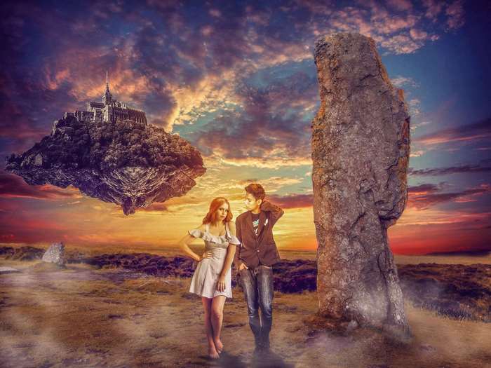 Couple in front of floating castle at sunset