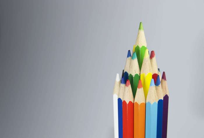 Group of colorful sharpened pencils arranged in a pyramid shape