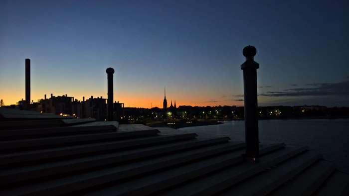 Helsinki skyline at dusk with Lyly rooftop in foreground