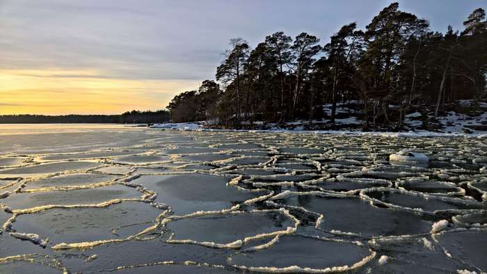Ice puzzle on Helsinki shore during winter sunset