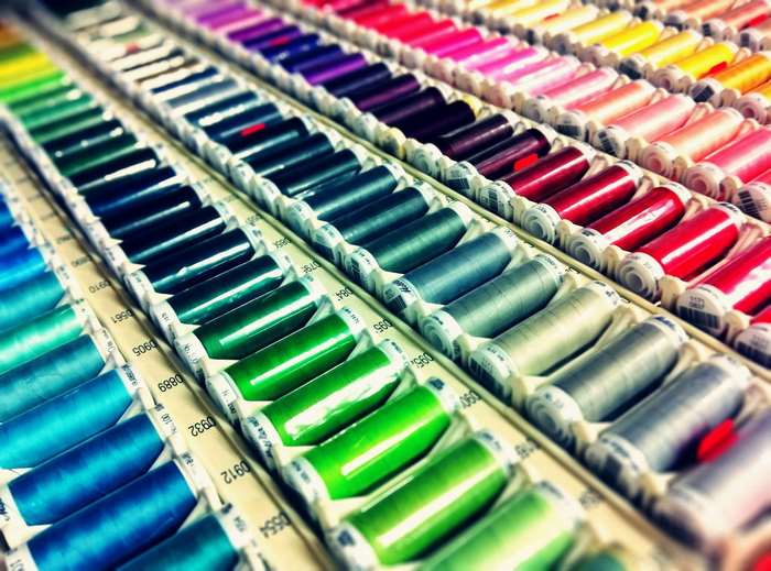 Rows of colorful sewing thread spools