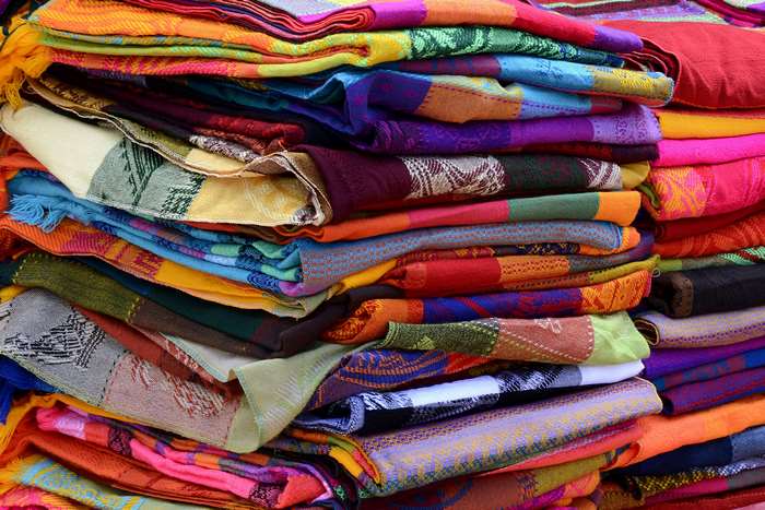 Pile of colorful woven Mexican textiles
