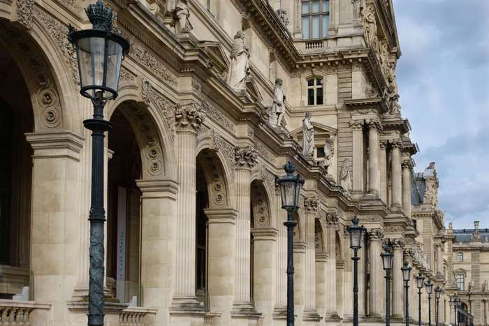 Louvre Museum architecture with street lamps in Paris
