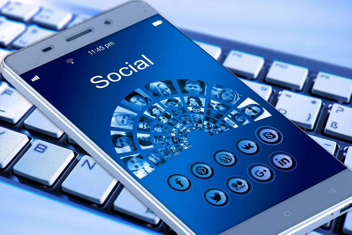 Smartphone displaying social media icons on a keyboard