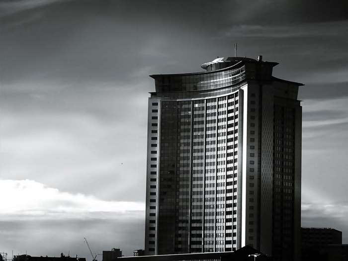 Modern skyscraper against a cloudy sky