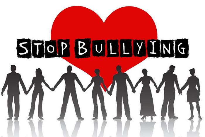 Stop Bullying message with diverse people holding hands
