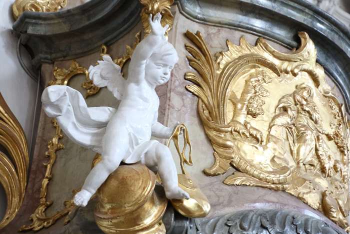 White angel statue with golden decorations