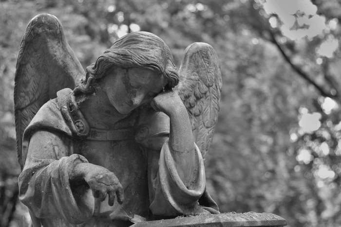 Sad angel statue in a cemetery