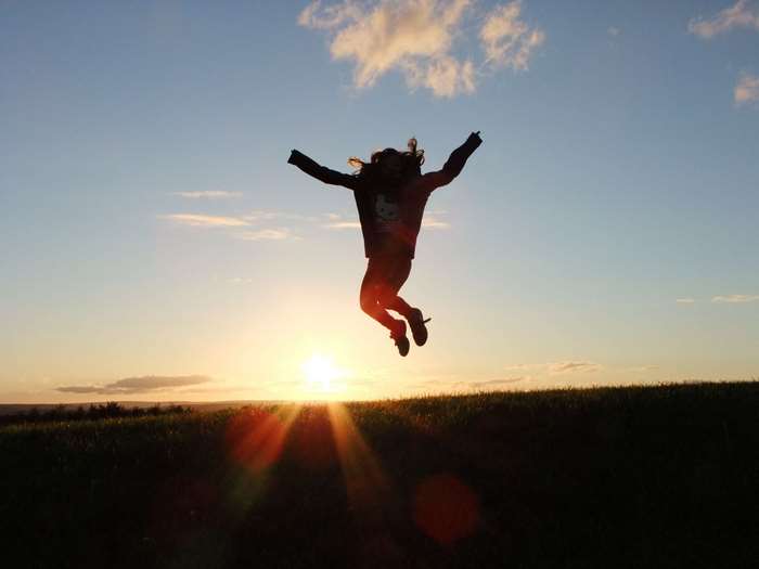 Girl jumping at sunset 4K