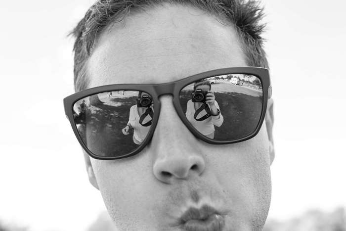 Man wearing sunglasses taking a selfie