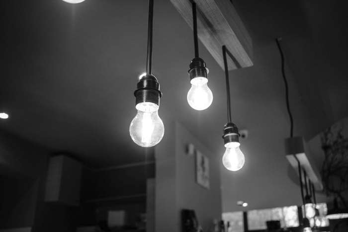 Black and white image of hanging light bulbs
