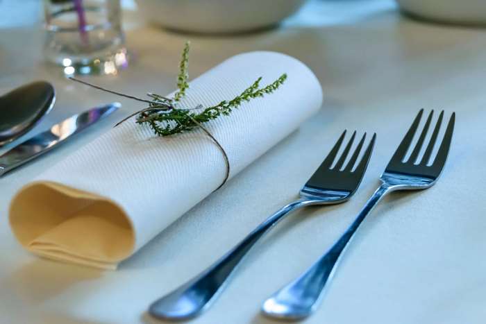 Table setting with forks and napkin