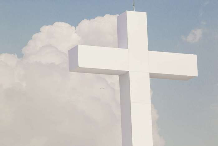 Large white cross against a cloudy sky
