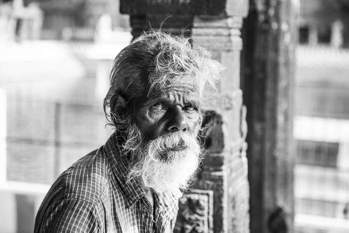 Monochrome portrait of an elderly man with a white beard