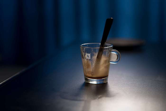 Espresso cup with spoon on a dark table