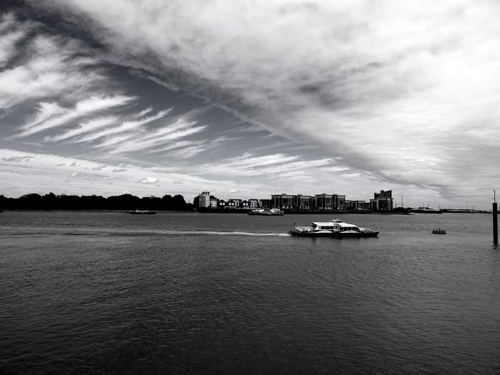 Black and white cityscape with boats on the water