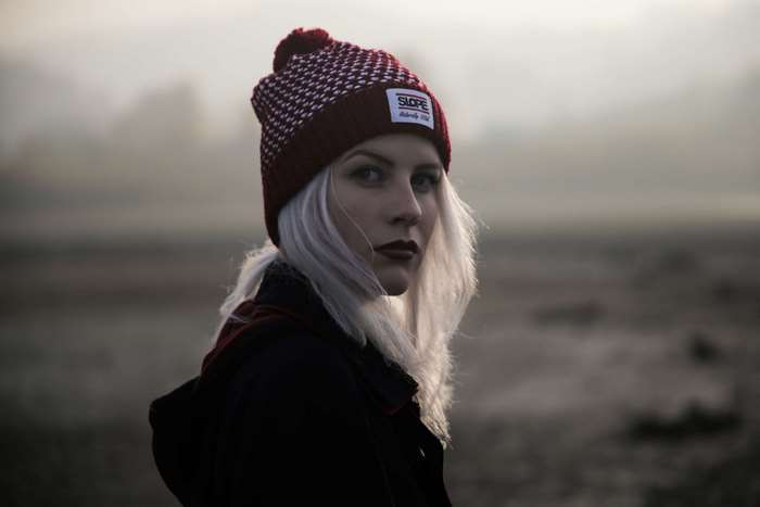 Woman wearing a beanie in foggy outdoors
