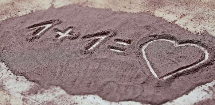 Japanese characters and heart drawn in sand