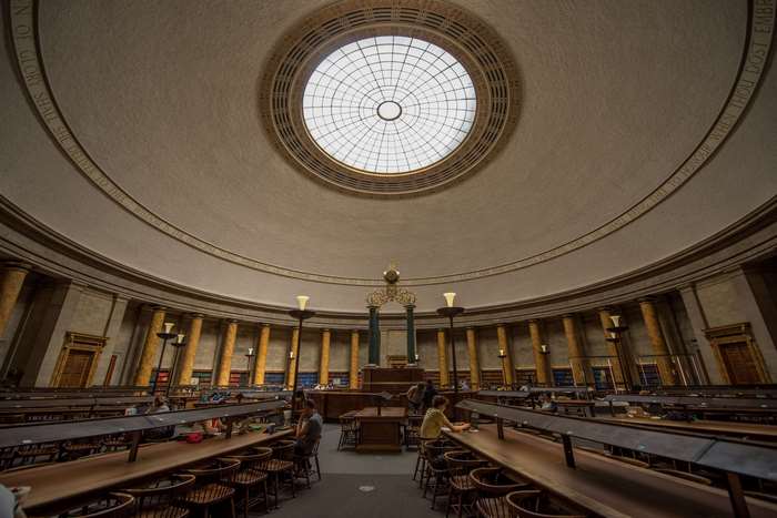 Interior of a grand library with a dome ceiling and pillars
