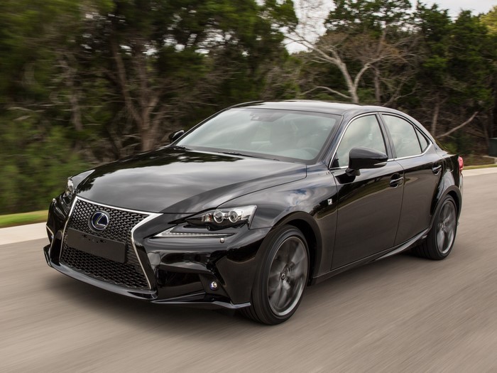 Black Lexus IS 300h F-Sport sedan driving on a road