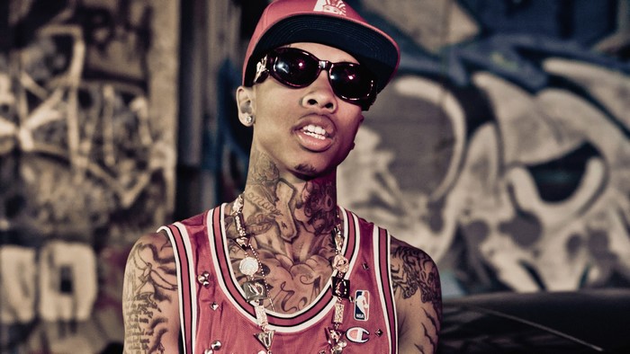 Tyga wearing sunglasses and a cap