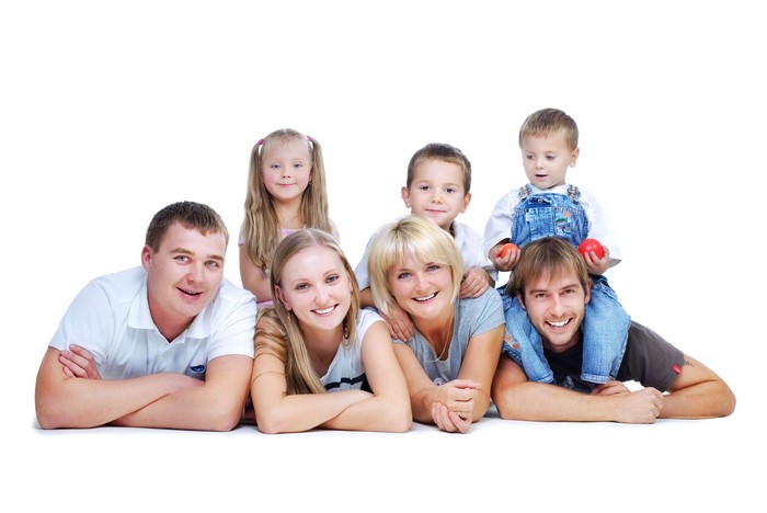 A happy family posing together on a white background