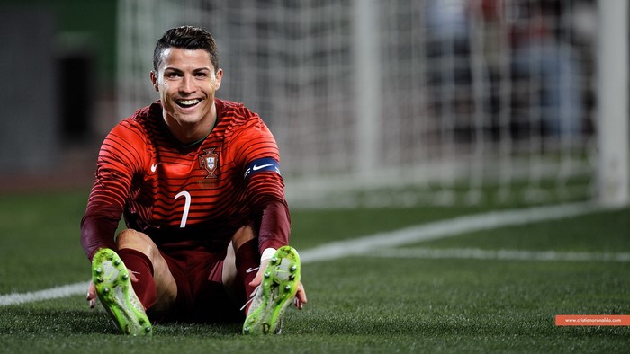 Cristiano Ronaldo of Portugal sitting on a football field