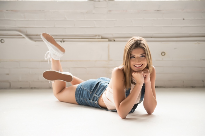 Smiling Young Woman Lying on the Floor