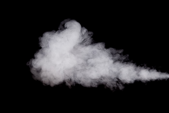 White smoke billowing against a black background