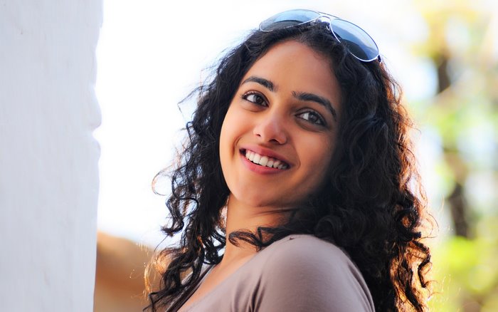 Nithya Menon smiling with sunglasses