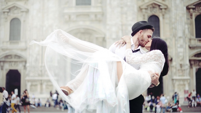 Romantic Wedding Kiss in Front of Historical Building