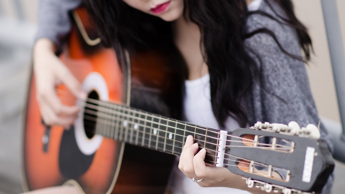 Girl playing acoustic guitar
