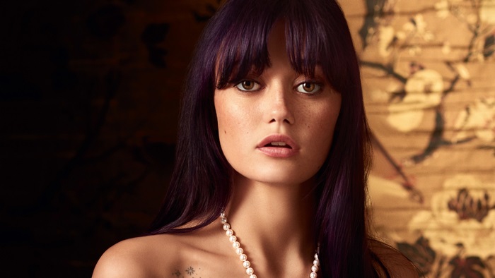 Ella Purnell with purple hair and pearl necklace