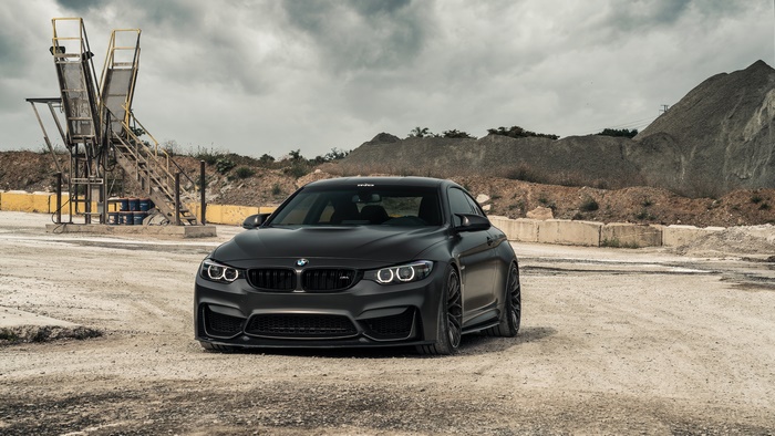 Matte Black BMW M4 Coupe in an Industrial Area