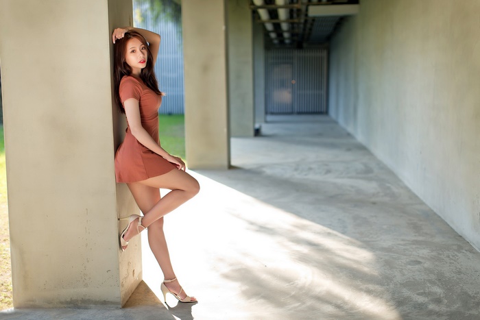 Brunette Woman in Brown Dress with High Heels