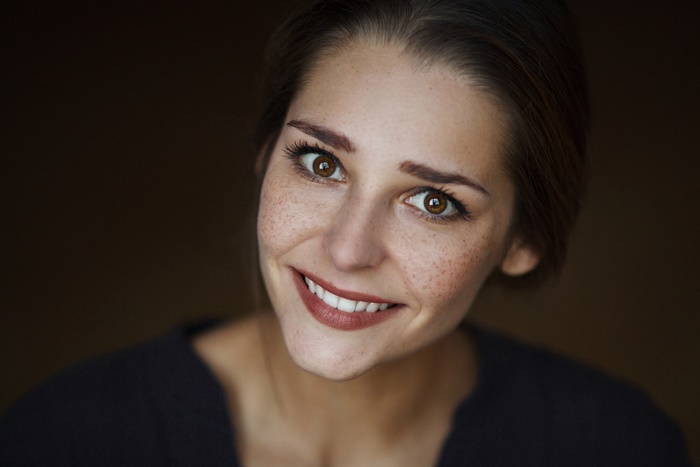 Woman with Freckles and Brown Eyes Smiling