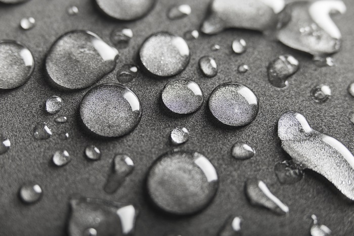Macro shot of water droplets on a dark surface