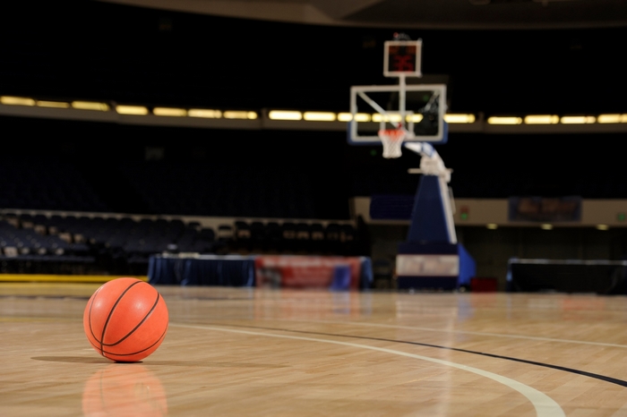 Basketball on a wooden court in an arena