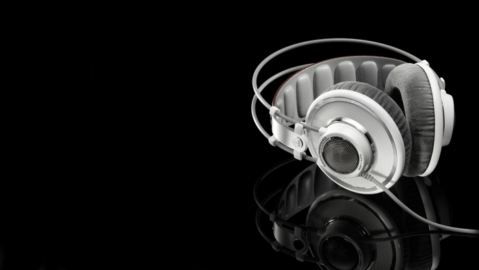 White headphones on a black reflective surface