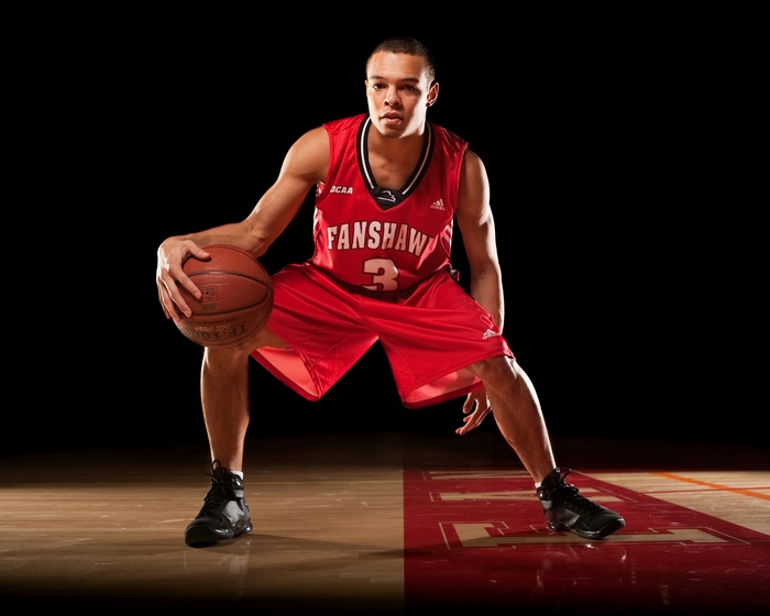 Basketball player dribbling on court