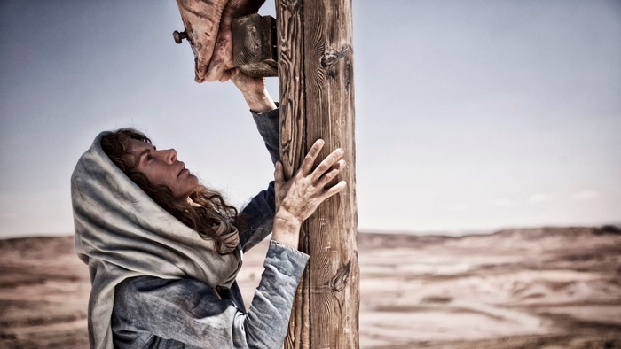 Woman reaching for Jesus on the cross