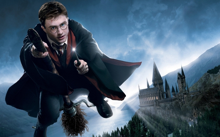 Harry Potter flying on a broomstick near Hogwarts