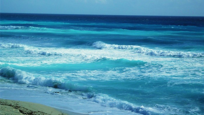 Ocean waves crashing on a sandy beach