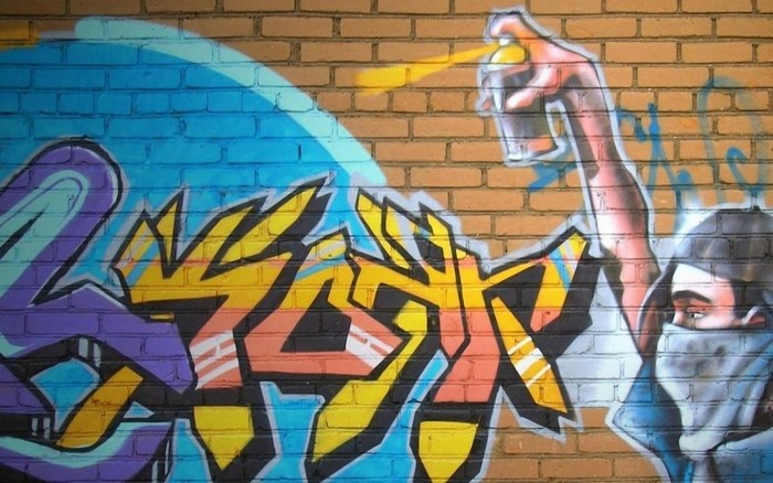 Graffiti art on brick wall with spray can