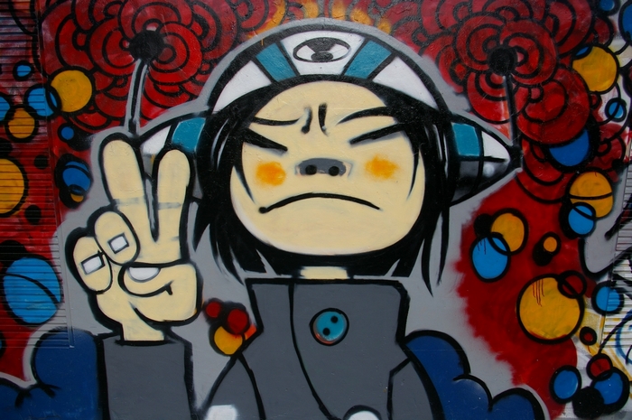 Graffiti of Noodle from Gorillaz with peace sign