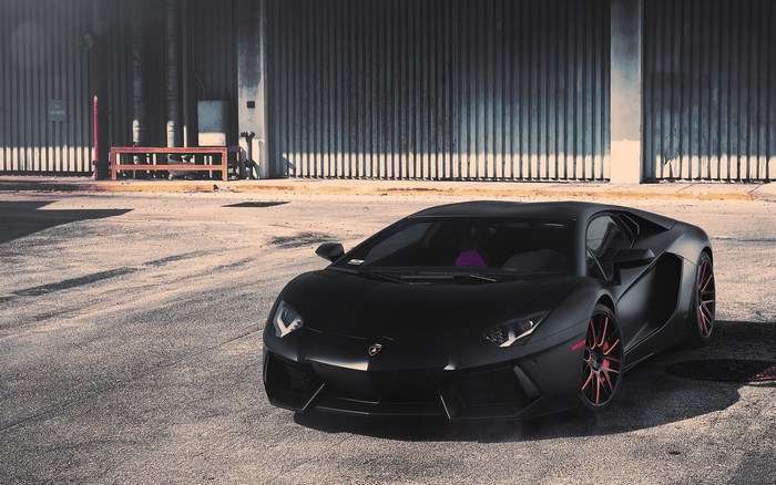 Matte black Lamborghini Aventador with red accents